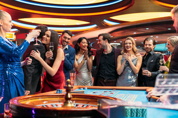 Successful Men and Women Partying in a Luxurious Casino. Young People Gambling at a Roulette Table, Putting High Stakes Bets. Entertainment Industry and Glamorous Lifestyle Concept