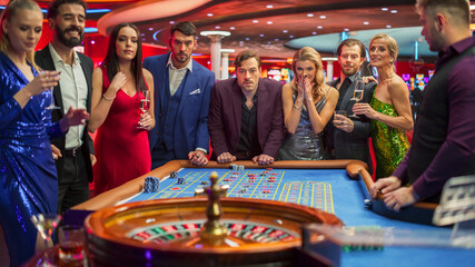 Elegantly Dressed Men and Women Enjoying Luxurious Atmosphere of a Casino. Cinematic Footage with...