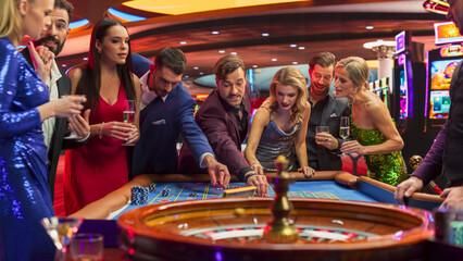 Footage of a Spinning Roulette Wheel. Female and Male Guests Placing Risky Bets while Playing Roulette. Crowd Celebrating a Positive Outcome and Cheering the Winner