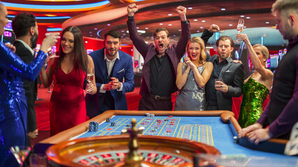 Footage of a Spinning Roulette Wheel. Excited Group of Diverse Casino Guests Placing Chips on a Table. Young Adults Bonding Over Winning Bets and Celebrations