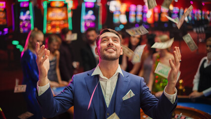 Portrait of an Excited Young Man Catching Money that is Flying From the Sky. Successful Gambler Won...
