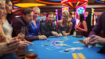 Group of Casino Goers Enjoying Time in a Modern Casino, Friends Placing Blackjack Bets,...