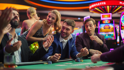 High-Stakes Poker Championship in Casino, Glamorous Players Place Bets, Reveal Cards. Player Triumphs, Celebrating His Jackpot Win against the Odds. Beautiful People Relaxing.  - obrazy, fototapety, plakaty