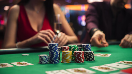 Poker Game in Casino: Betting All in Chips at the Poker Table. In the Blurred Background, Anonymous...