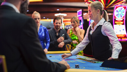 Happy and Cheerful Group of Casino Guests Placing Bets and Celebrating Winning Luck and Skill in...