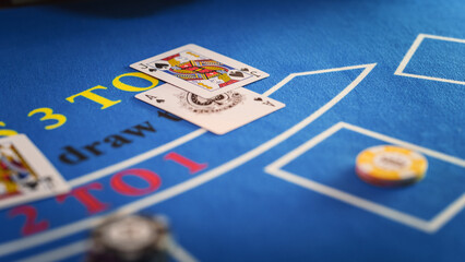 Close Up on Casino Baccarat Gambling Table: Anonymous Croupier Dealing Playing Cards on a Blackjack Table with Bet Chips in Place. Poker Chips are Being Exchanged as the Lucky Guest Wins the Jackpot