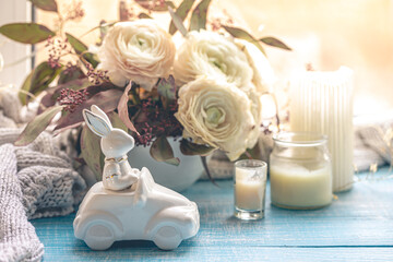 Festive Easter background with decorative ceramic hare and flowers.