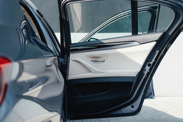 Interior of a business-class car, white perforated leather, aluminum, black lacquer, interior details.