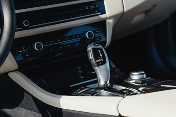 Interior of a business-class car, white perforated leather, aluminum, black lacquer, interior details.