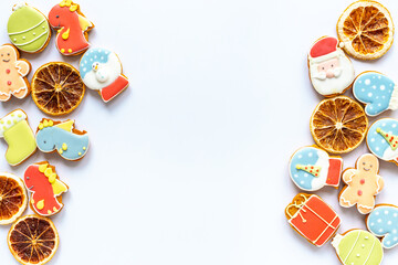 Christmas cookies in the shape of a dragons and New Years decoration with candied oranges