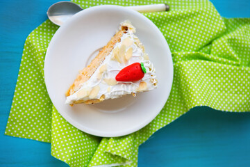 Piece of carrot cake with icing and little carrot