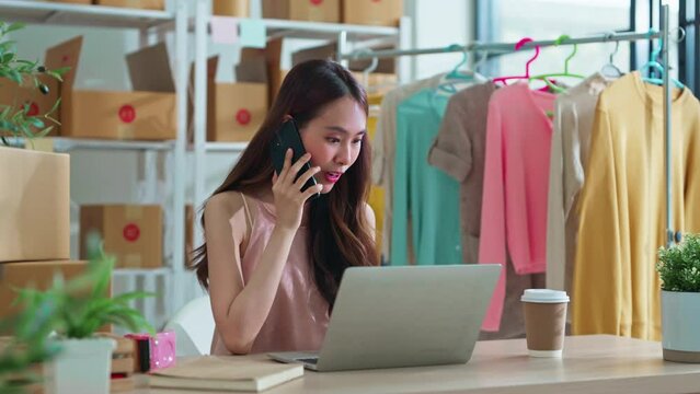 small business fashion store shop onwer discuss checking business order contract deal at home while conversation on smartphone and checking cloth inventory and order checking for make sure 