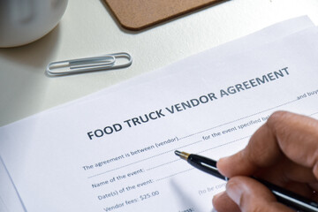 Businessman applying for Food Truck Vendor agreement application form. Selective focus.