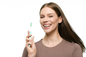 Young beautiful woman with toothbrush isolated on white background