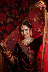 Portrait of beautiful indian bride wearing kundan jewelery