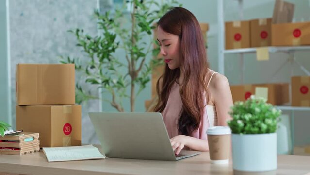 small business fashion store shop onwer discuss checking business order contract deal at home while conversation on ;aptop and tablet and checking cloth inventory and order checking for make sure 