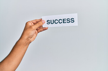 Hand of caucasian man holding paper with success word over isolated white background