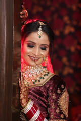 Portrait of shy indian bride with closed eyes