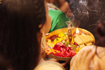 Hand holding pooja thali for indian ritual