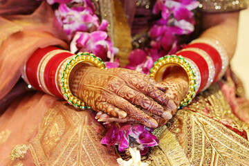 Closeup of mehendi on bride hand with bangles