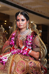 Portrait of indian bride praying at wedding