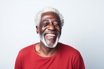 Obraz premium professional portrait studio photo of a handsome old afro american tatooed man model with perfect clean teeth laughing and smiling. isolated on white background. for ads and web design