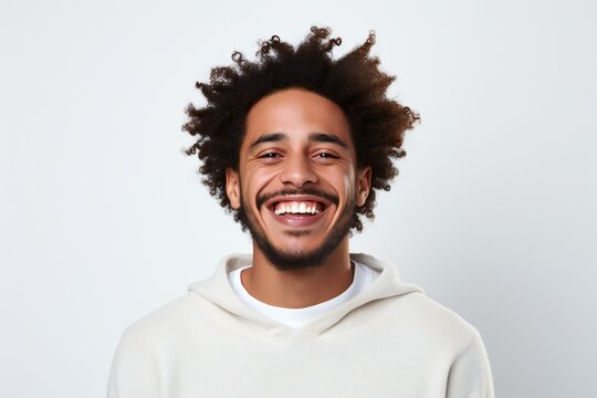 professional portrait studio photo of a handsome young afro american tatooed man model with perfect clean teeth laughing and smiling. isolated on white background. for ads and web design