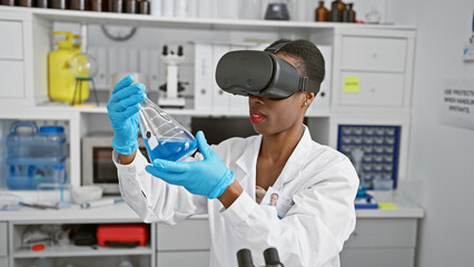 Beautiful african american woman scientist engrossed in high-tech vr science experiment at lab,...