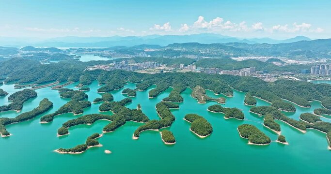 Aerial video of clear lake water and green island with mountain natural landscape in Hangzhou. Drone surround shooting.