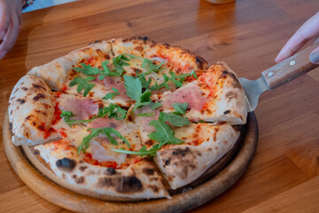 Pizza Prosciutto is a classic Italian pizza that is made with a thin, crispy crust, tomato sauce, and prosciutto crudo, a type of cured ham from Parma, Italy. 