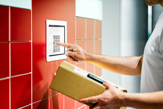 Package locker machine. Parcel service. Box and mobile phone. Man using code to collect delivery. Shipment terminal at post office. Automatic express mail station. Pick up and collection automat.