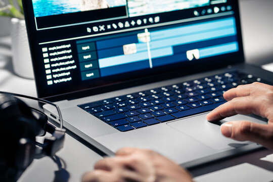 Video edit and film making. Editor and movie production software in laptop computer. Cut content with multimedia maker. Creative special effects. Videographer working on a montage project timeline.