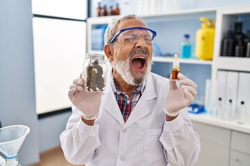 Frustrated and furious mature man scream in anger at laboratory, strong expression of rage over...