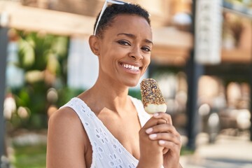 African american woman smiling confident eating ice cream at street