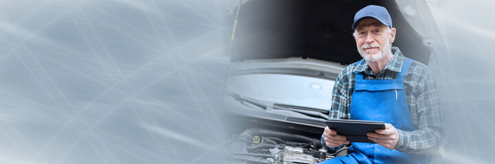 Mechanic using digital tablet for checking car engine; panoramic banner