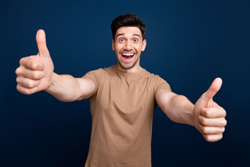 Portrait of impressed overjoyed man with stubble wear beige outfit showing you thumbs up good job...