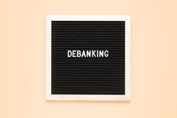 The word denanking on black letter board over isolated beige background