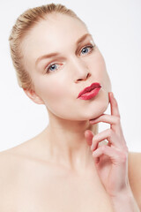 Obraz na płótnie Canvas Portrait, skincare and woman in red lipstick, makeup and cosmetics in studio isolated on a white background. Face, model and beauty in spa facial treatment for wellness, touch skin and healthy glow