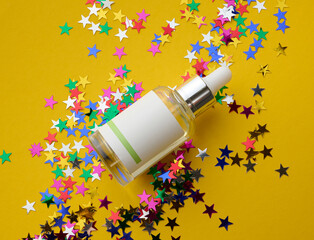 Glass bottle with paper label and pipette for oils and cosmetics