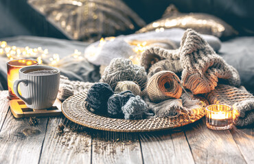 Cozy composition with balls of thread and a knitted element in the interior.