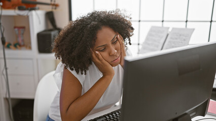 African american woman feeling stressed in a music studio