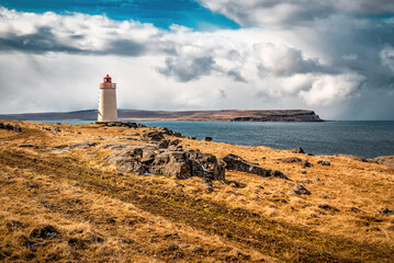 Breathtaking view of Skarsviti lighthouse in Vatnsnes peninsula on a clear day in North Iceland