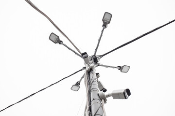 Obraz premium A modern street LED lighting pole for sity. Urban electro-energy technologies. Savings on street urban road lighting. A security camera is also attached to the pole.