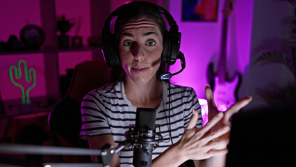Confident young hispanic woman gamer dominating digital entertainment, beautiful streamer in her...