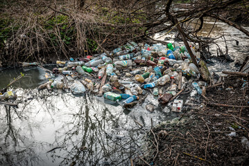 Plastic garbage in the river , pollution and environment concept