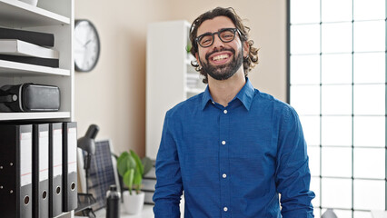 Young hispanic man business worker smiling confident at the office