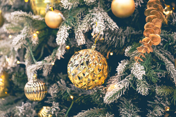 Gold Christmas decorations on the Christmas tree close-up.