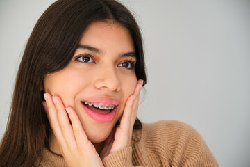 Portrait of a Latin female teenager with dental braces.
