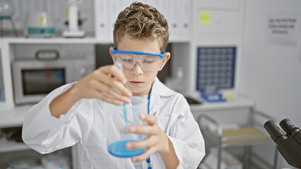 Adorable blond boy playing scientist, pouring liquid into a test tube in a cozy home lab, combining...