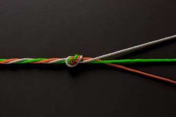 Conceptualized photo for communal unity and harmony in India. Three ropes in Indian tri-colors tied...